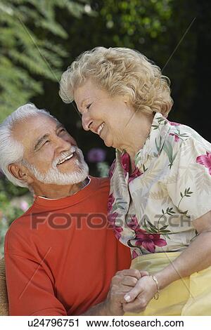 Stock Image - Senior couple laughing outdoors. Fotosearch
