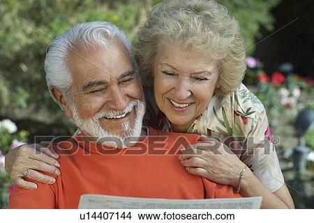 Senior couple reading newspaper in garden View Large Photo Image Picture - Senior couple reading newspaper in garden. Fotosearch