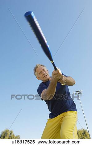 Senior man swinging baseball bat View Large Photo Image Stock Photography - Senior man swinging baseball bat. Fotosearch