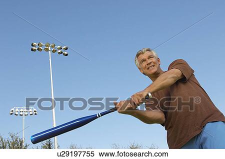 Senior man swinging baseball bat View Large Photo Image Stock Photography - Senior man swinging baseball bat. Fotosearch