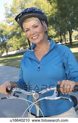 Senior woman on bicycle, portrait View Large Photo Image Stock Image - Senior woman on bicycle, portrait. Fotosearch