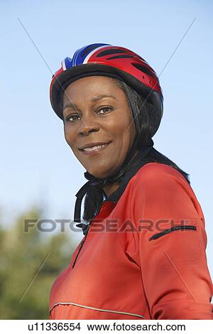 Senior woman wearing cycling helmet, outdoors, portrait View Large Photo Image Picture - Senior woman wearing cycling helmet, outdoors, portrait. Fotosearch