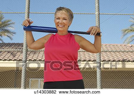 Senior woman with baseball bat outdoors, portrait View Large Photo Image Stock Image - Senior woman with baseball bat outdoors, portrait. Fotosearch