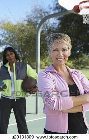 Senior women on outdoor basketball court, portrait View Large Photo Image Stock Photo - Senior women on outdoor basketball court, portrait. Fotosearch