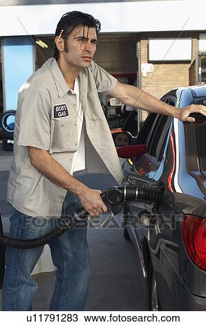 Service attendant pumping gas View Large Photo Image Stock Image - Service attendant pumping gas. Fotosearch