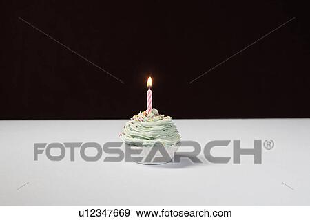 Single cupcake with birthday candle View Large Photo Image Stock Photo - Single cupcake with birthday candle. Fotosearch