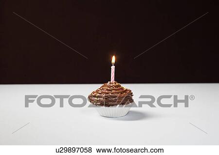 Single cupcake with birthday candle View Large Photo Image Stock Photo - Single cupcake with birthday candle. Fotosearch