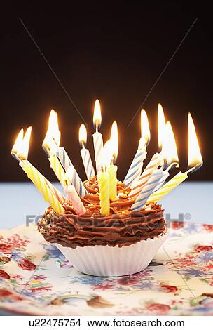 Single cupcake with birthday candles View Large Photo Image Picture - Single cupcake with birthday candles. Fotosearch