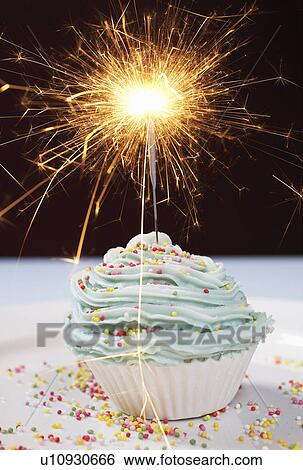 Single cupcake with lit sparkler View Large Photo Image Stock Photograph - Single cupcake with lit sparkler. Fotosearch