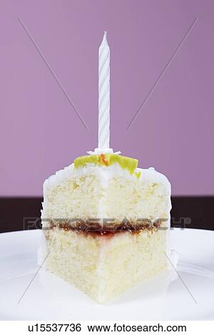 Slice of cake with birthday candle, close-up View Large Photo Image Stock Photograph - Slice of cake with birthday candle, close-up. Fotosearch