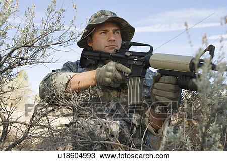 Soldier aiming machine gun, close-up View Large Photo Image Stock Image - Soldier aiming machine gun, close-up. Fotosearch