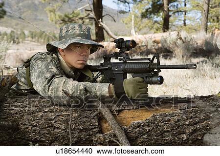 Soldier aiming machine gun, leaning on log View Large Photo Image Stock Image - Soldier aiming machine gun, leaning on log. Fotosearch