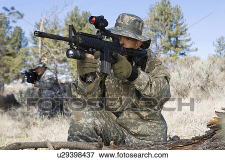 Stock Photo - Soldier aiming machine gun. Fotosearch