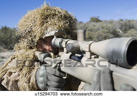 Soldier in grass camouflage pointing rifle View Large Photo Image Stock Image - Soldier in grass camouflage pointing rifle. Fotosearch