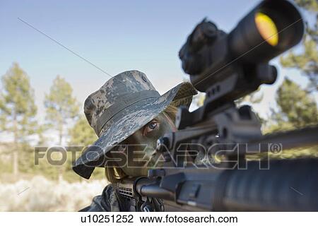 Stock Image - Soldier in pointing rifle. Fotosearch