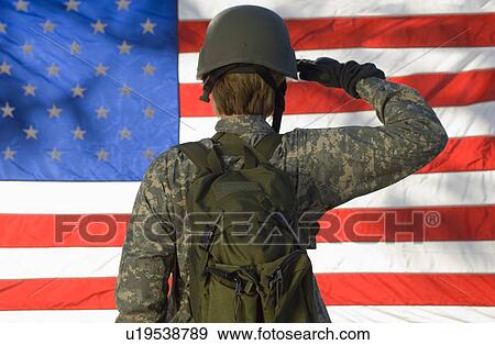 Stock Photo - Soldier saluting in front of American flag. Fotosearch