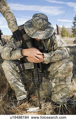 Picture - Soldier sitting, looking down. Fotosearch