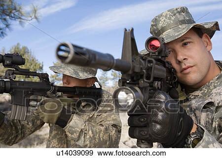 Stock Photo - Soldiers aiming machine guns, close-up. Fotosearch