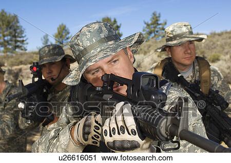 Stock Image - Soldiers aiming machine guns. Fotosearch