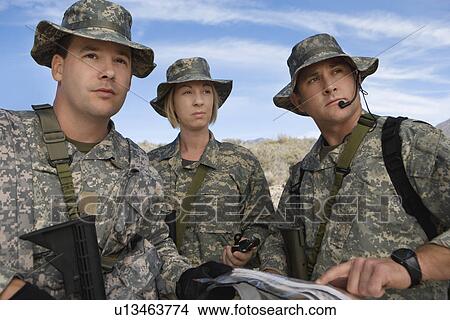 Soldiers in field looking at map View Large Photo Image Picture - Soldiers in field looking at map. Fotosearch