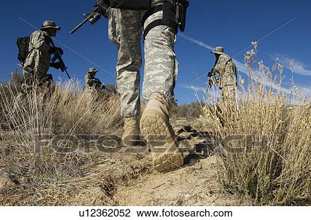 Soldiers walking in desert, low section View Large Photo Image Stock Image - Soldiers walking in desert, low section. Fotosearch