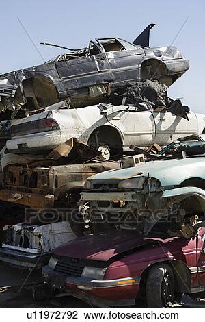 Stock Image - Stacked cars in junkyard. Fotosearch