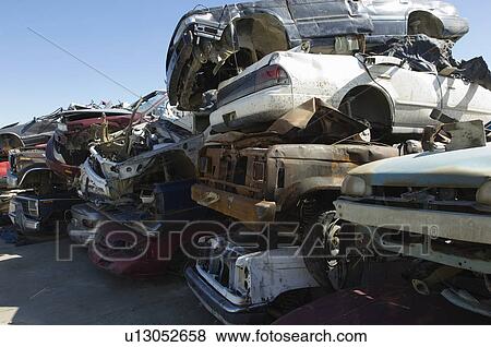 Stock Photo - Stacked cars in junkyard. Fotosearch