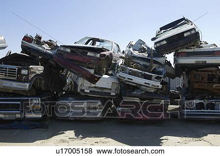 Stock Photo - Stacked cars in junkyard. Fotosearch