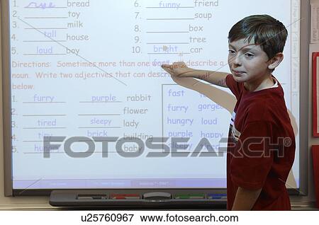 Stock Photo - Student in Classroom Doing Math. Fotosearch