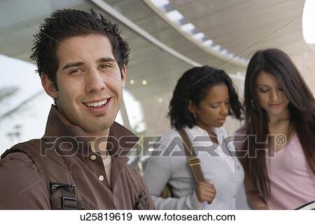 Stock Photo - Students smiling in hallway at school, portrait. Fotosearch