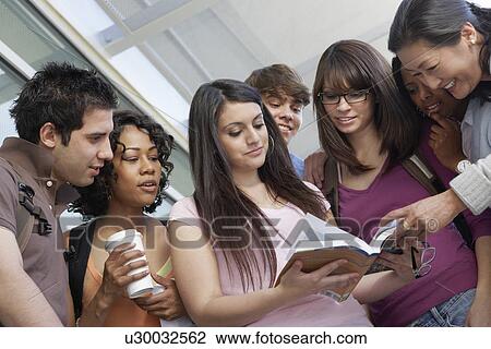 Stock Image - Students with teacher at school, low angle view. Fotosearch