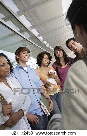 Stock Photo - Students with teacher at school. Fotosearch