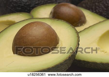 Stock Image - Studio shot of halved avocados. Fotosearch