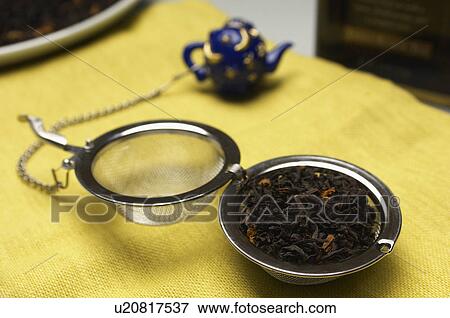 Stock Photo - Tea strainer with leaves. Fotosearch