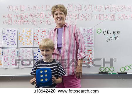 Stock Image - Teacher and Little Boy in Front of Class. Fotosearch