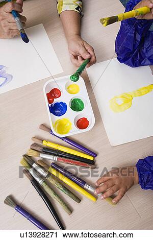 Stock Image - Teacher and Student Painting. Fotosearch