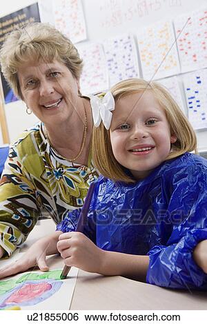 Stock Photograph - Teacher and Student Painting. Fotosearch