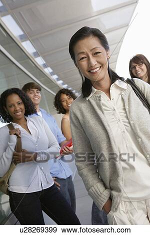 Teacher and students smiling outside school, portrait View Large Photo Image Stock Photo - Teacher and students smiling outside school, portrait. Fotosearch