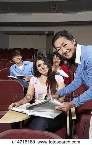 Teacher explaining something to female student View Large Photo Image Stock Photo - Teacher explaining something to female student. Fotosearch