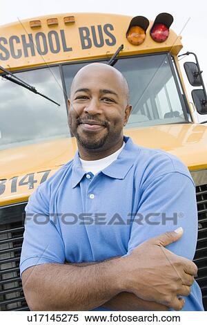Stock Photography - Teacher in Front of School Bus. Fotosearch