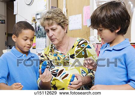 Teacher Talking with Elementary Students View Large Photo Image Stock Photo - Teacher Talking with Elementary Students. Fotosearch