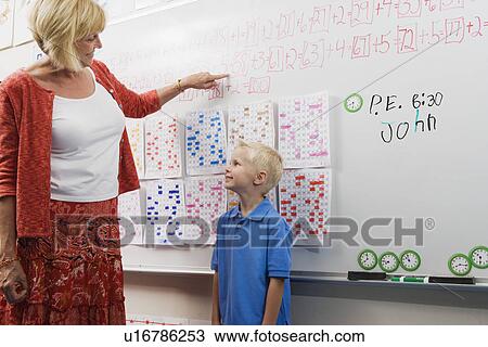 Stock Image - Teacher Talking with Little Boy. Fotosearch