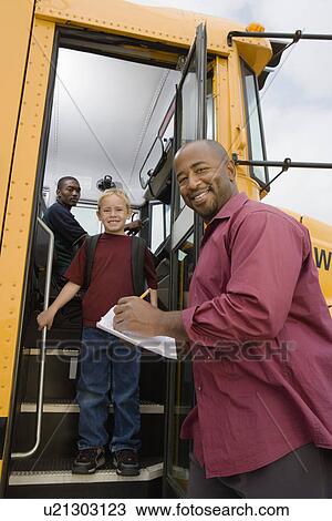 Stock Image - Teacher Unloading Elementary Students from School Bus. Fotosearch