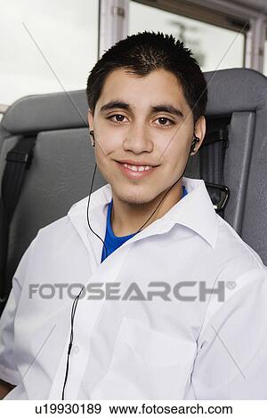 Stock Photo - Teenage Boy Listening to MP3 Player on Bus. Fotosearch