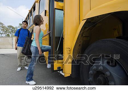 Stock Image - Teenage Girl Getting on School Bus. Fotosearch