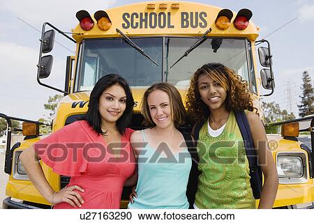 Stock Image - Teenage Girls by School Bus. Fotosearch