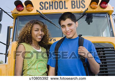 Stock Image - Teenagers by School Bus. Fotosearch