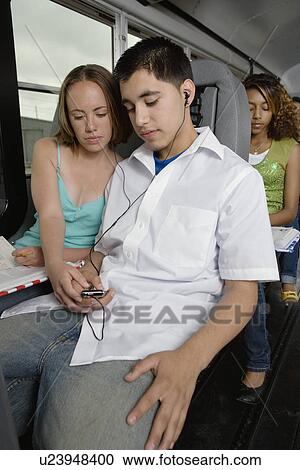 Teenagers Listening to MP3 Player While Riding School Bus View Large Photo Image Stock Image - Teenagers Listening to MP3 Player While Riding School Bus. Fotosearch