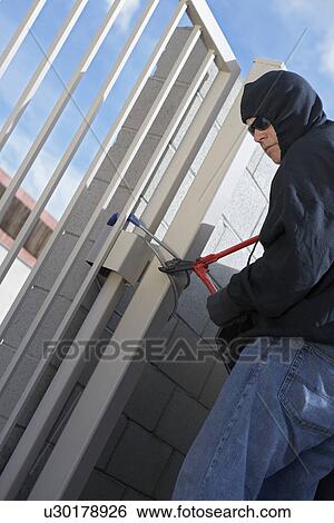 Stock Photograph - Thief cutting lock. Fotosearch