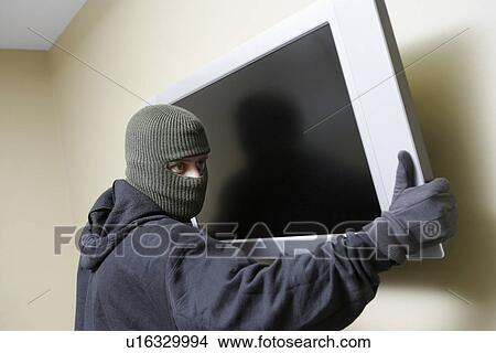 Thief stealing flat screen television View Large Photo Image Picture - Thief stealing flat screen television. Fotosearch